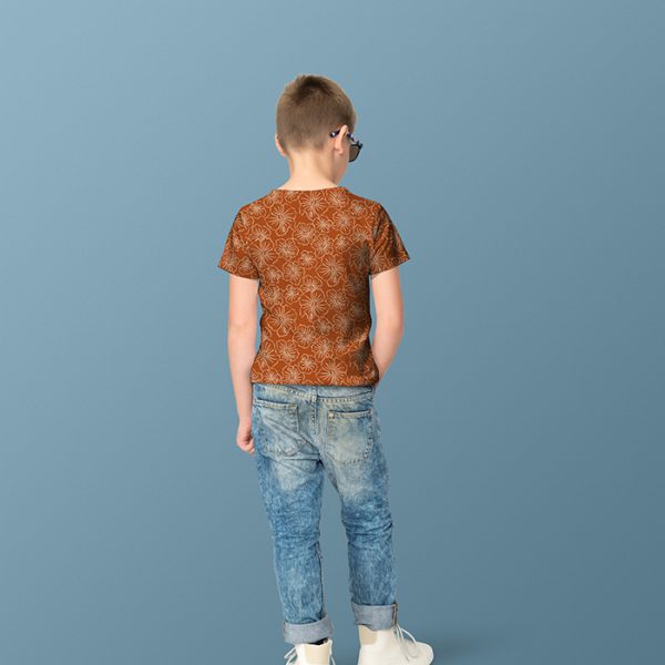 Apparel mockup of a boy wearing a shirt with a pattern from the Retro Jungle Collection by Elisa Mink.